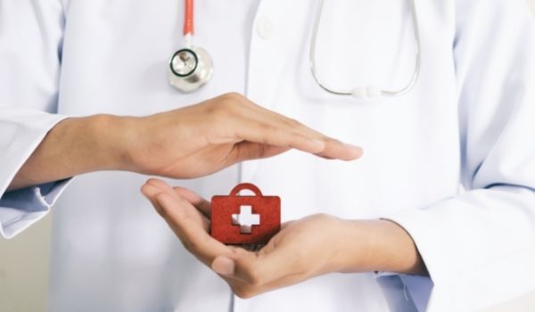 a nurse holding a red cross brick