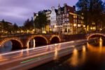 Amsterdam canal boat light trails at night