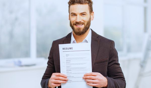 a man holding up his resume