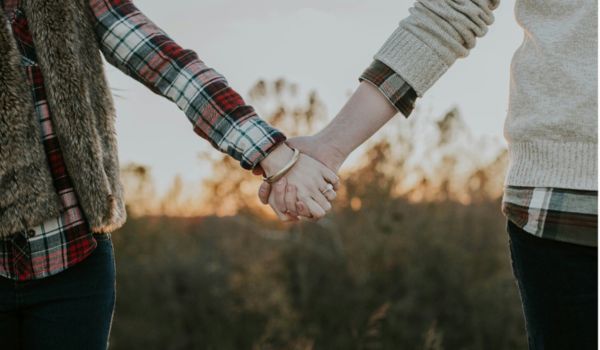 two women holding hands