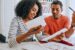 a couple sits at the table budgeting