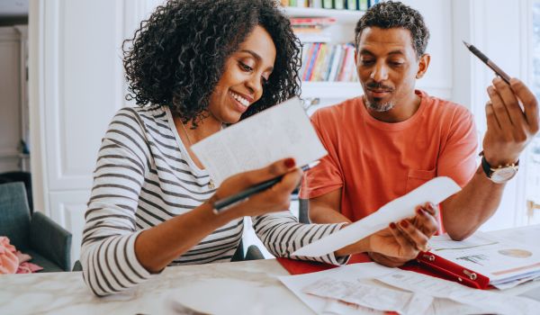 a couple sits at the table budgeting