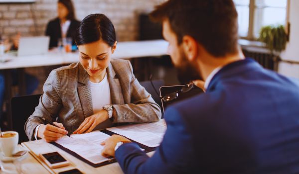 a woman signs an emloyement contract