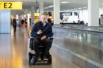 a man in a self-driving wheelchair at Schiphol airport