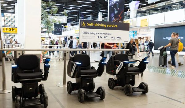 a row of three self-driving wheelchairs at schiphol