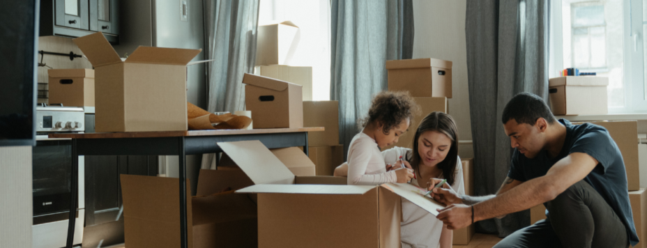 a family of three unpacking after moving