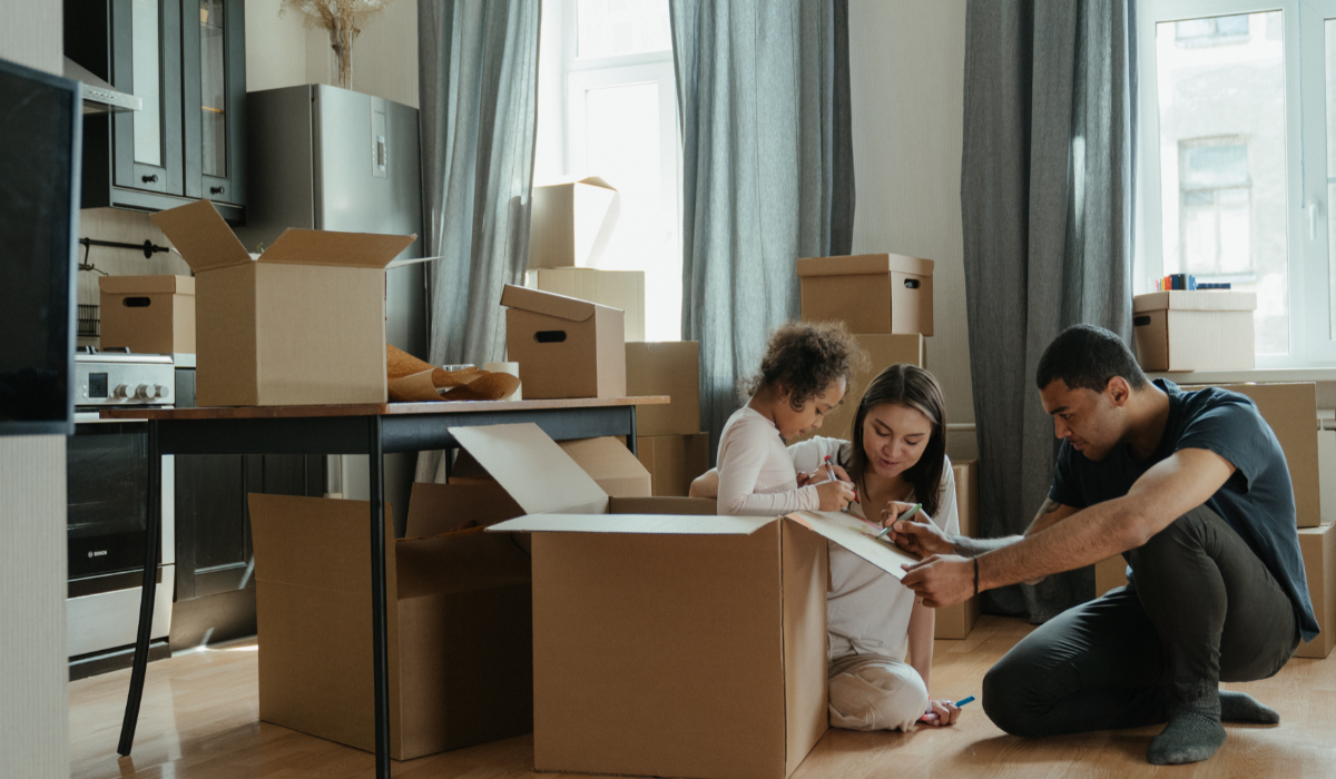 a family of three unpacking after moving