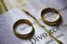 Two wedding rings set on a divorce contract