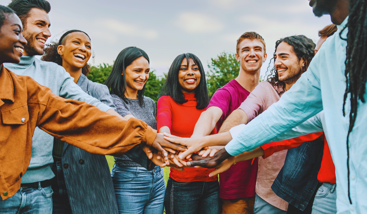 A multi ethnic group of young people standing in a circle