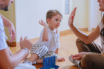 a happy child playing a game with his parents