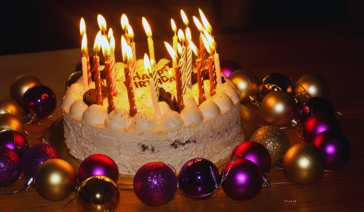 a birthday cake with lit candles