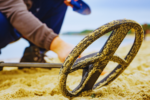 a metal detector laying in the sand